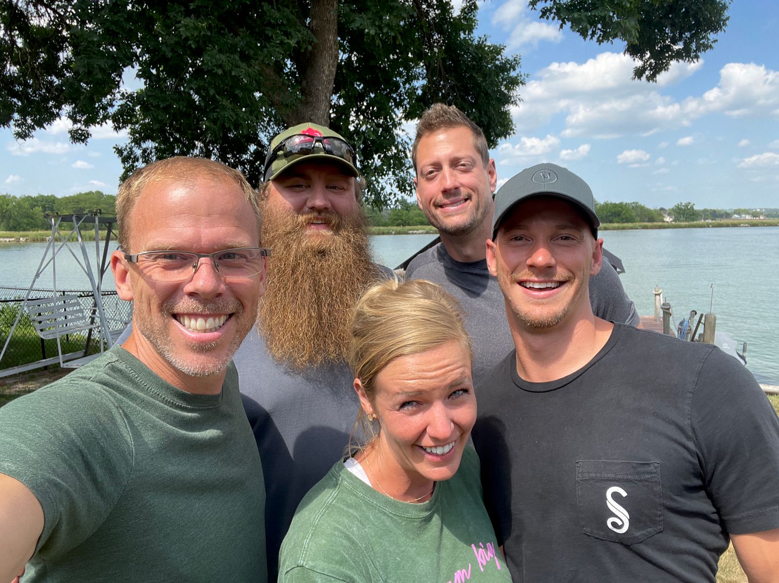 Scott with a client team outside by a lake